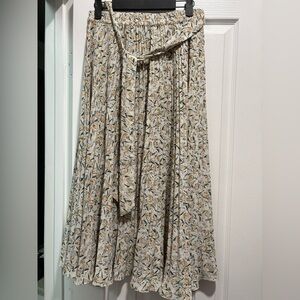 Skies are blue, high waisted flowy skirt with yellow green white coloring